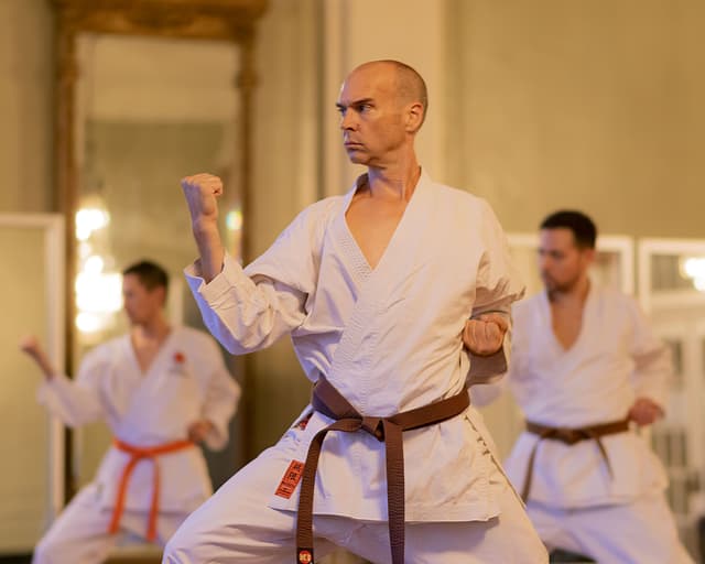 Men in martial arts uniform and form during their martial arts class in the New Orleans Athletic Club